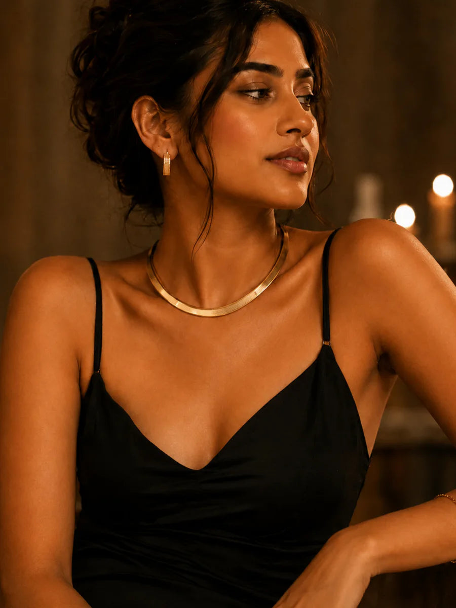 Warm-tone gold jewellery styled with a black evening look